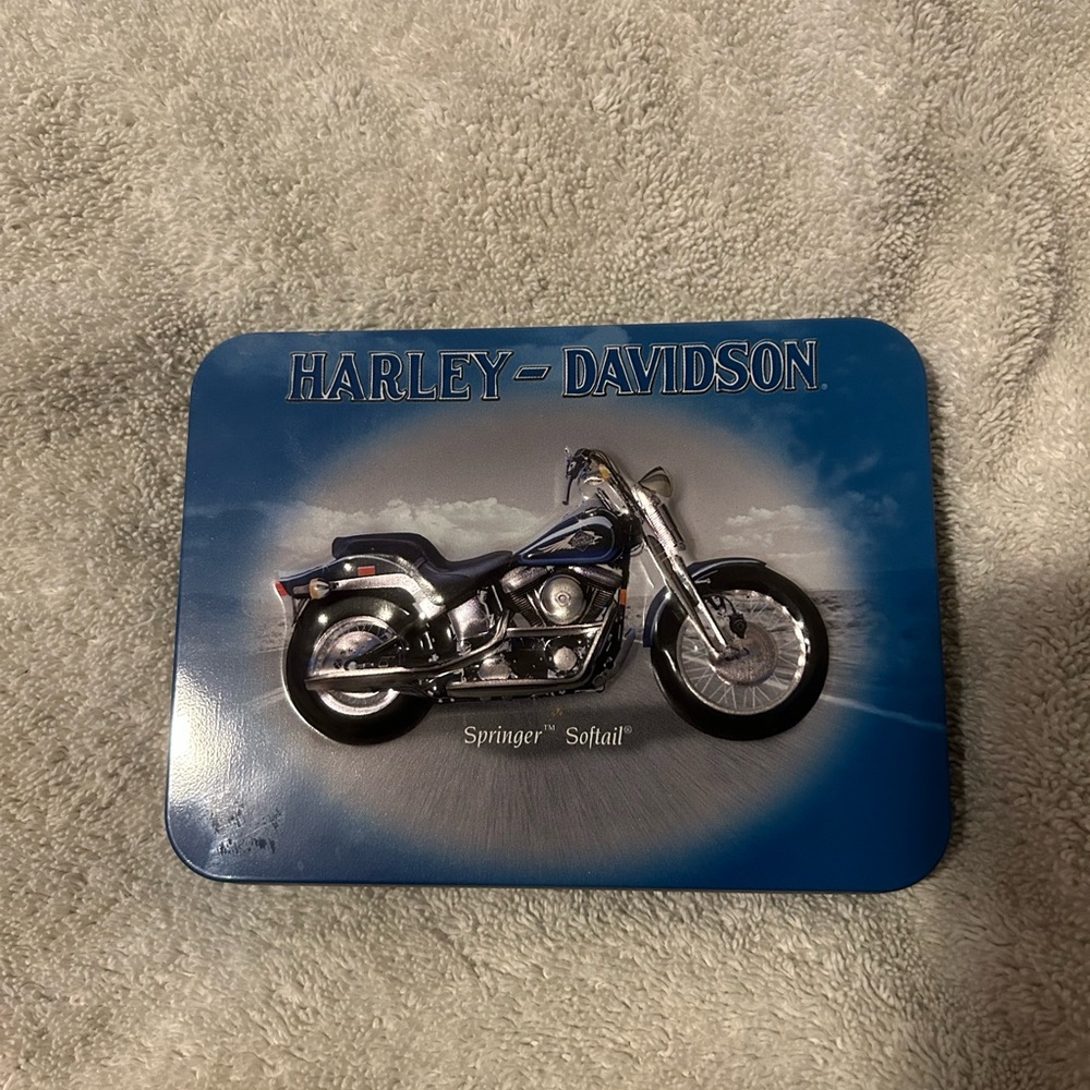 Harley-Davidson Blue and Silver Motorcycle with Two decks of cards inside